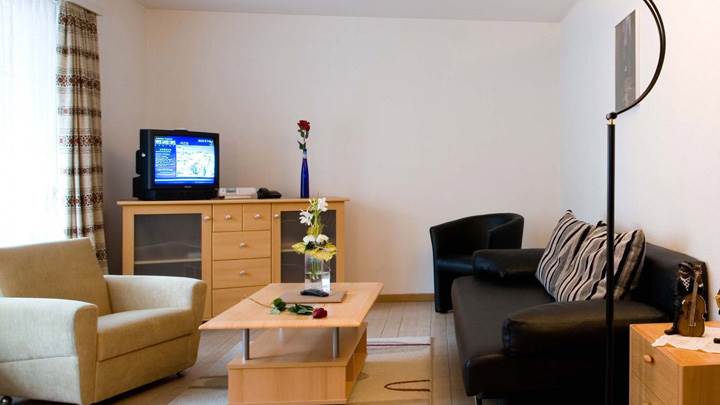 White Background And Wooden Furniture in TV Room